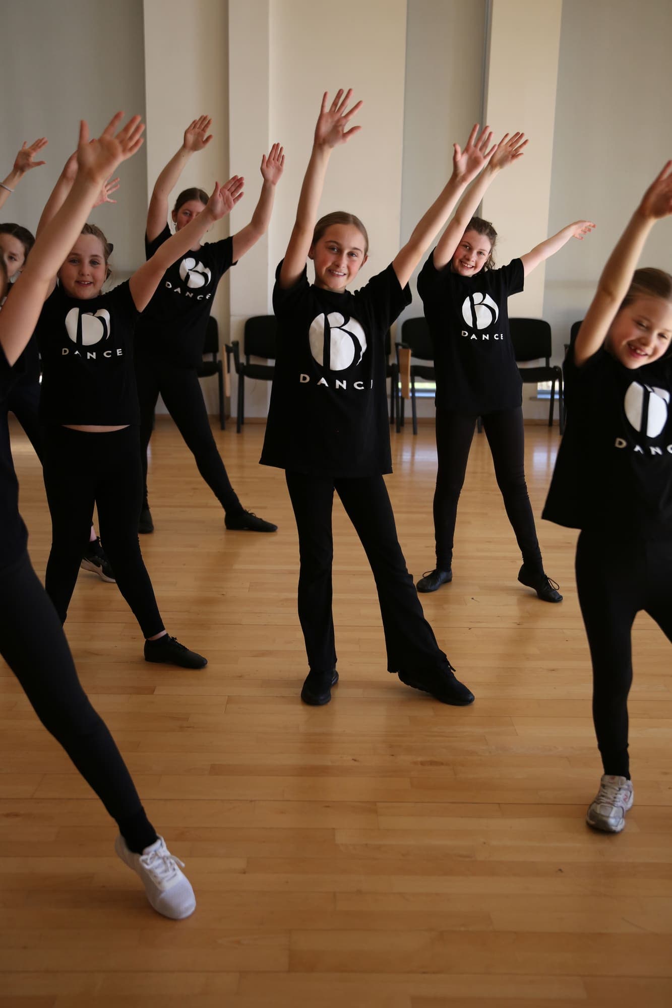 A class reaching up together mid-routine