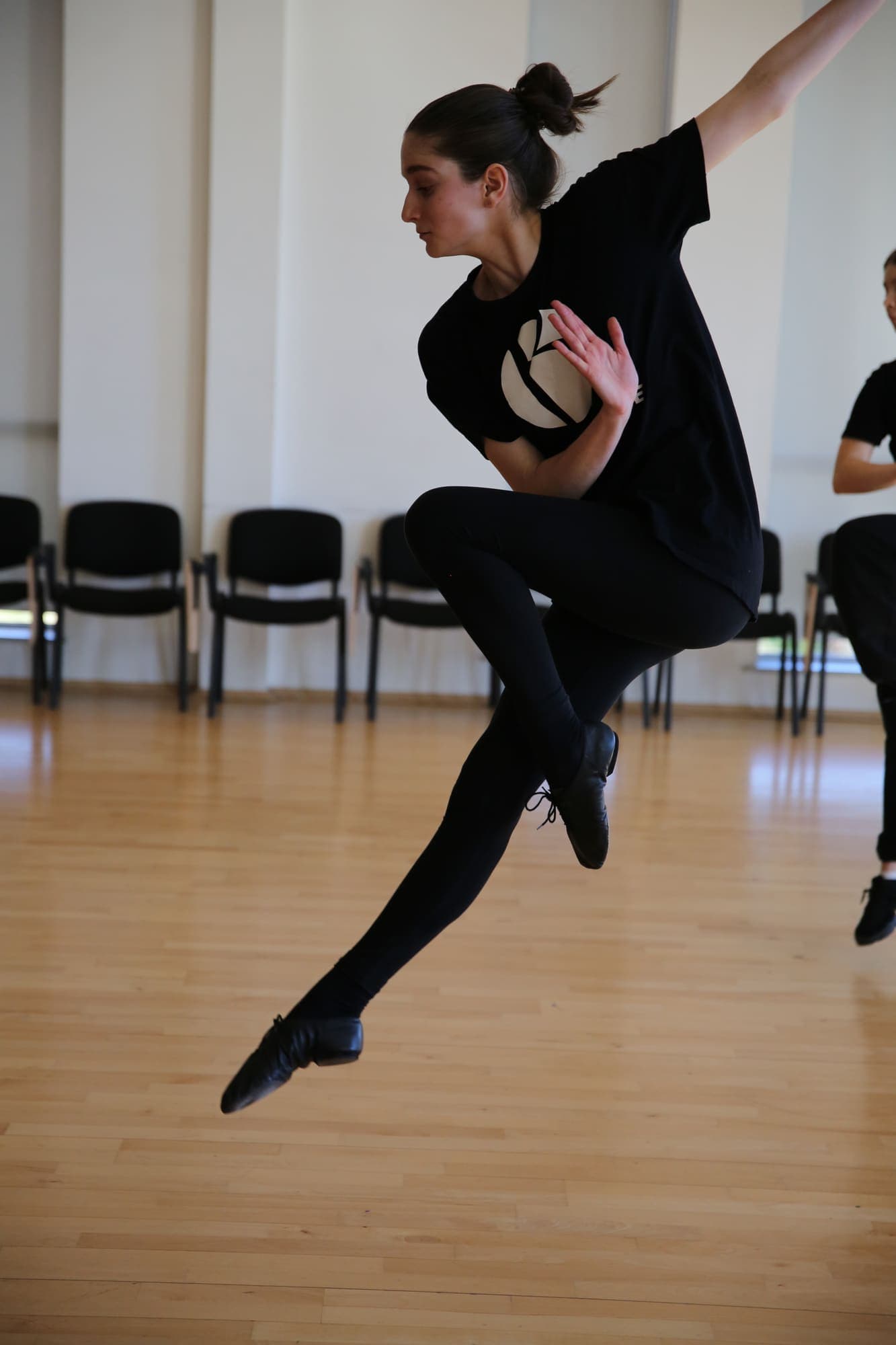 A Brilliant Dance student leaping across the studio